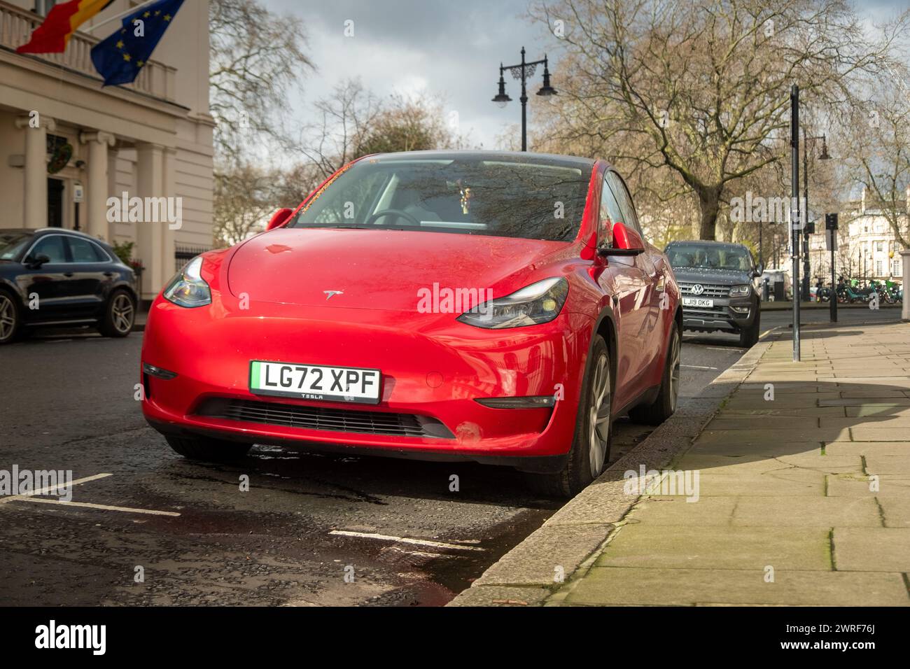 LONDON- FEBRUARY 19, 2024: Tesla Model 3 parked on upmarket  residential street in Belgravia Stock Photo