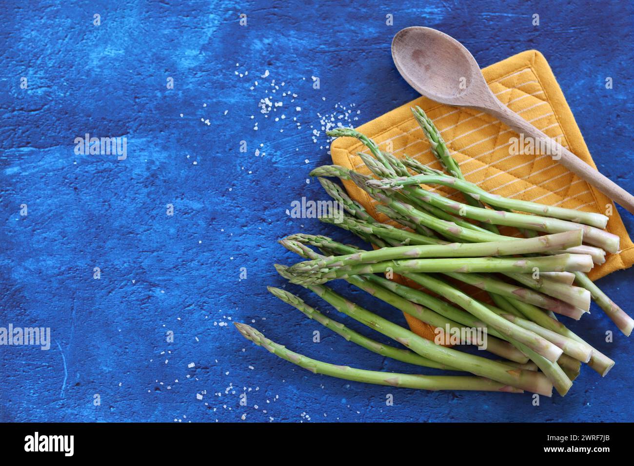 Bunch of fresh green asparagus close up  photo. Raw asparagus top view. Healthy eating concept. Natural vitamins and antioxidants. Stock Photo