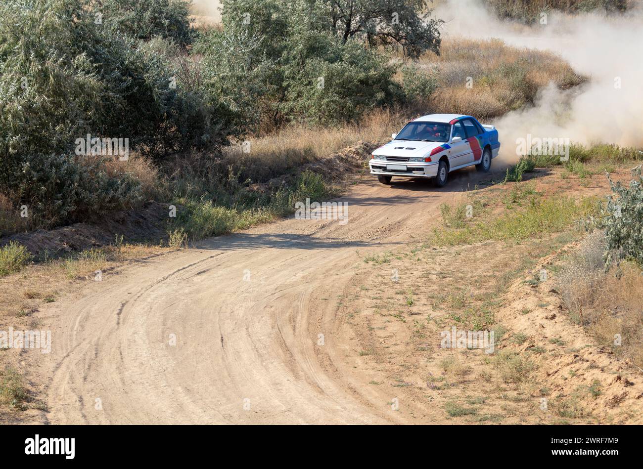 Sunny summer day. Dusty rally track. A rally car makes a lot of dust in a turn 20 Stock Photo