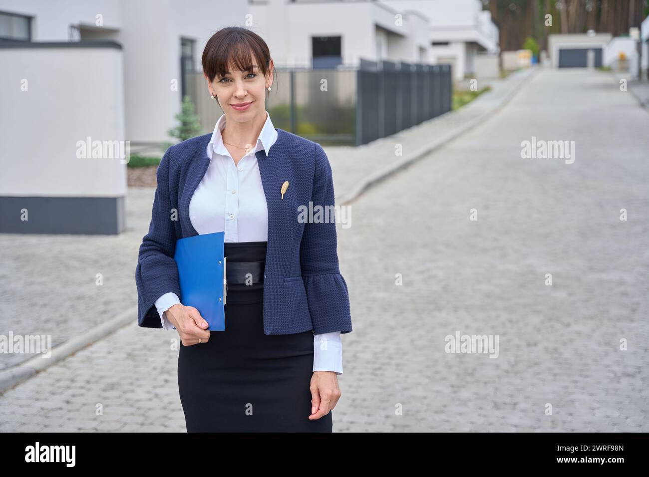 Woman has a blue folder with documents in her hands Stock Photo - Alamy