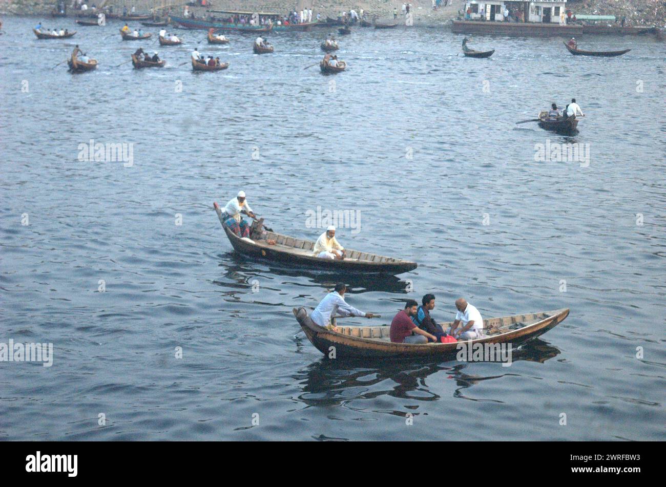Dhaka, Bangladesh. 12th Mar, 2024. Boatman ferry passengers across the