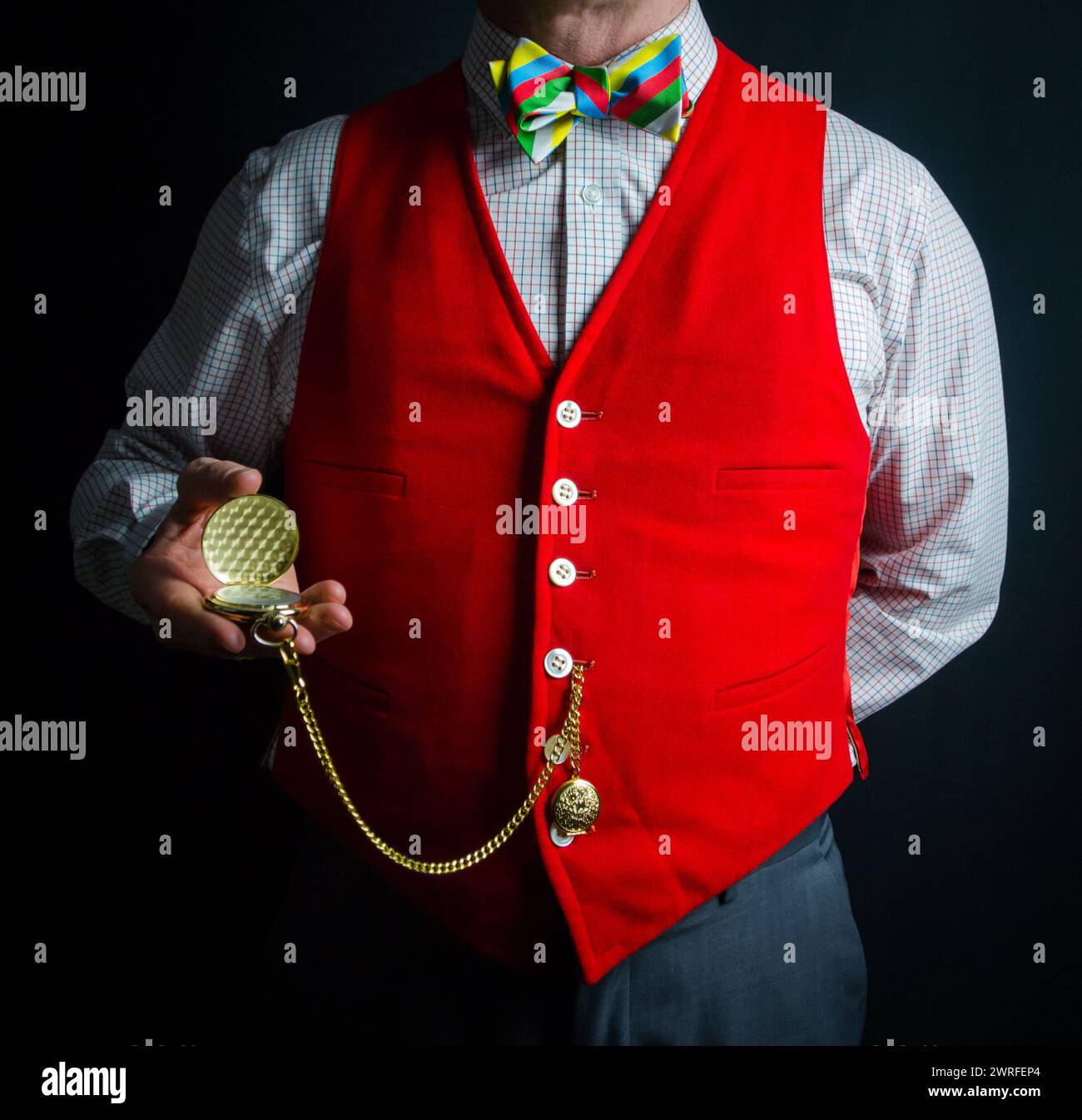 Gentleman in Red Waistcoat and Colorful Bow Tie Holding Gold Pocket