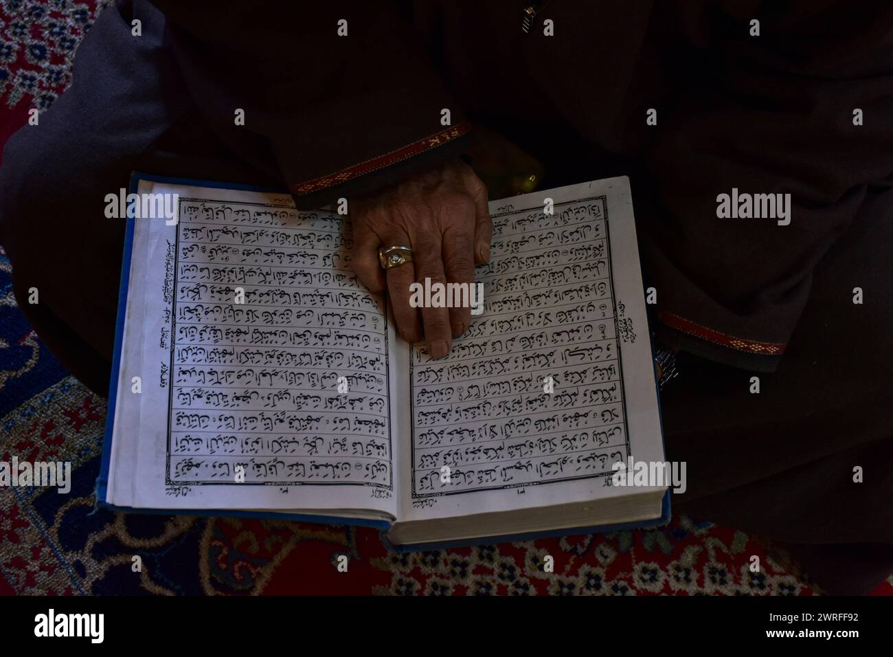 A Kashmiri Muslim recites the Holy Quran inside the shrine of Syed ...