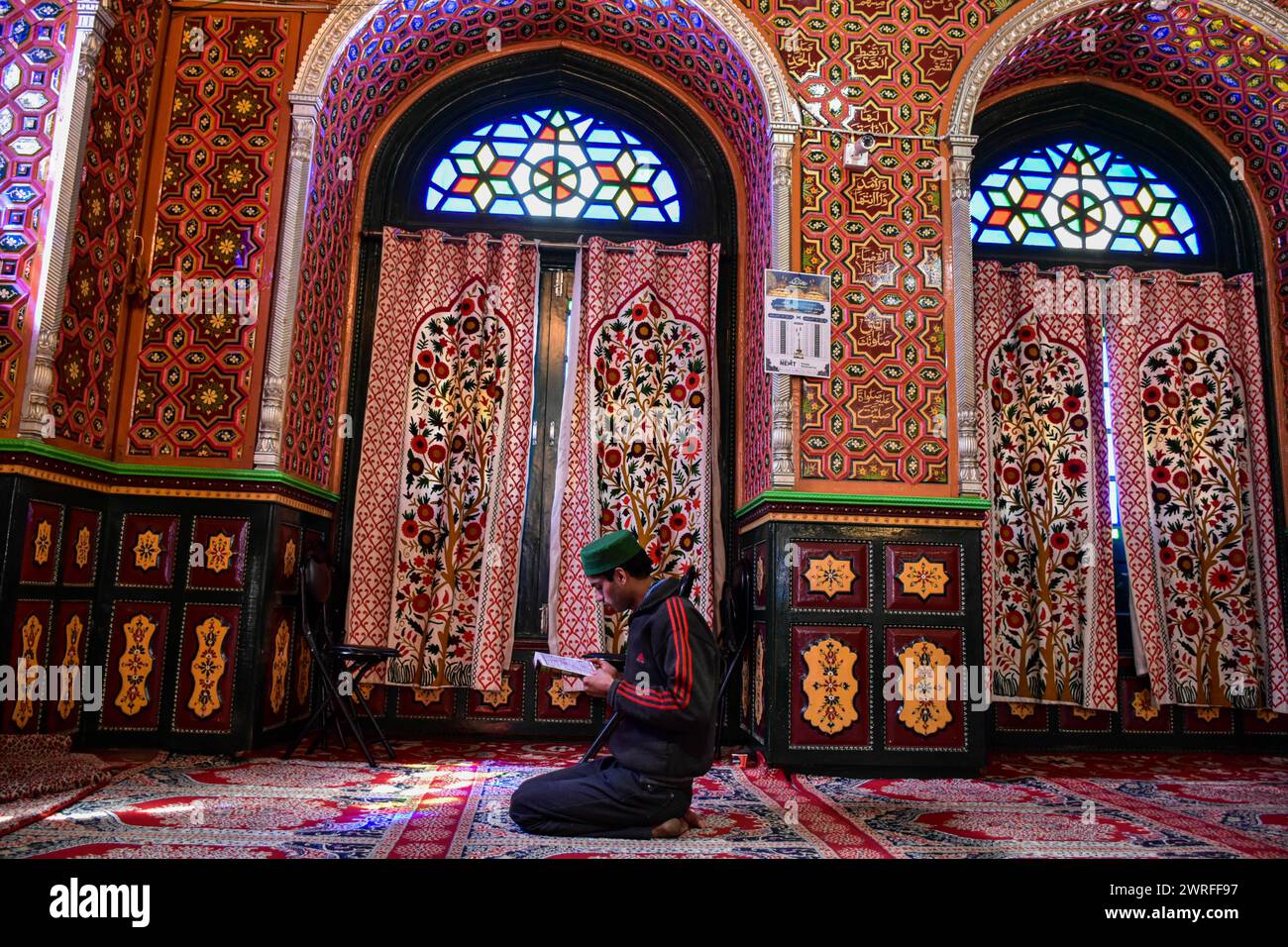 A Kashmiri Muslim recites the Holy Quran inside the shrine of Syed ...