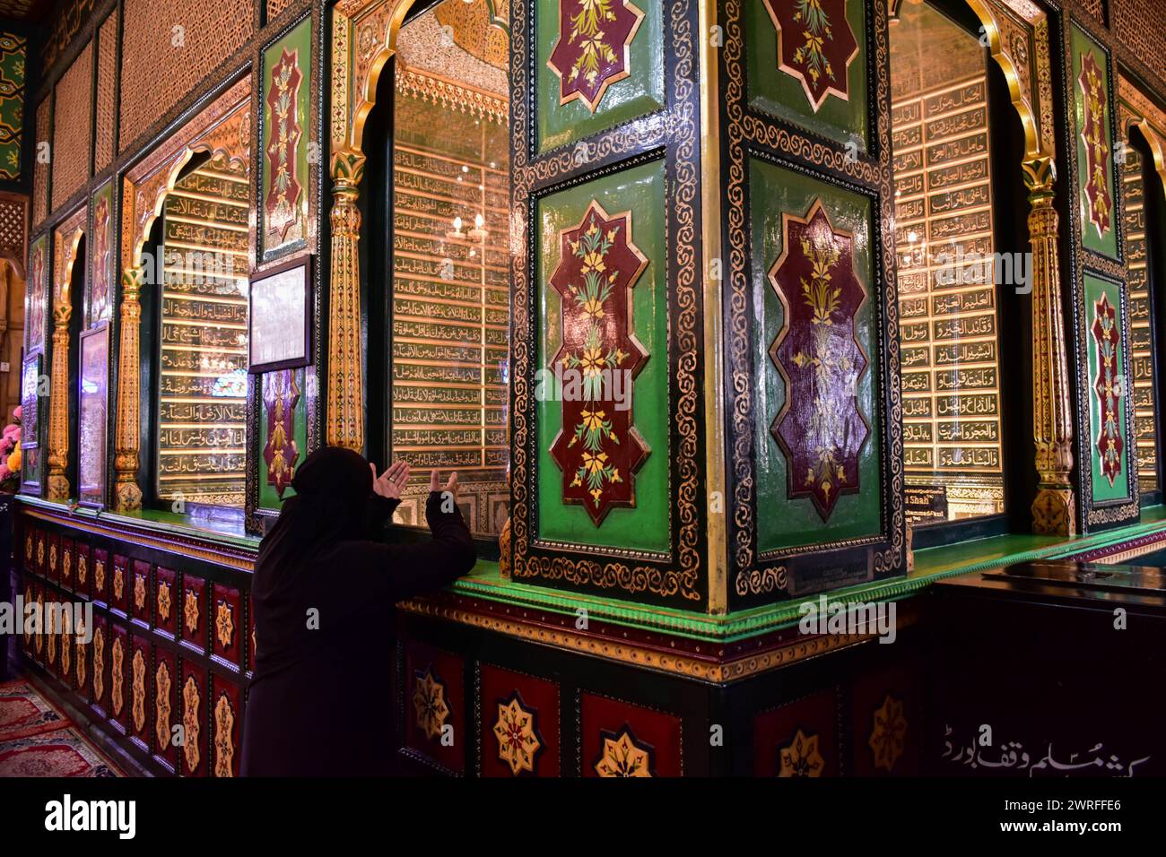 A Kashmiri Muslim woman prays inside the shrine of Syed Abdul Qadir ...