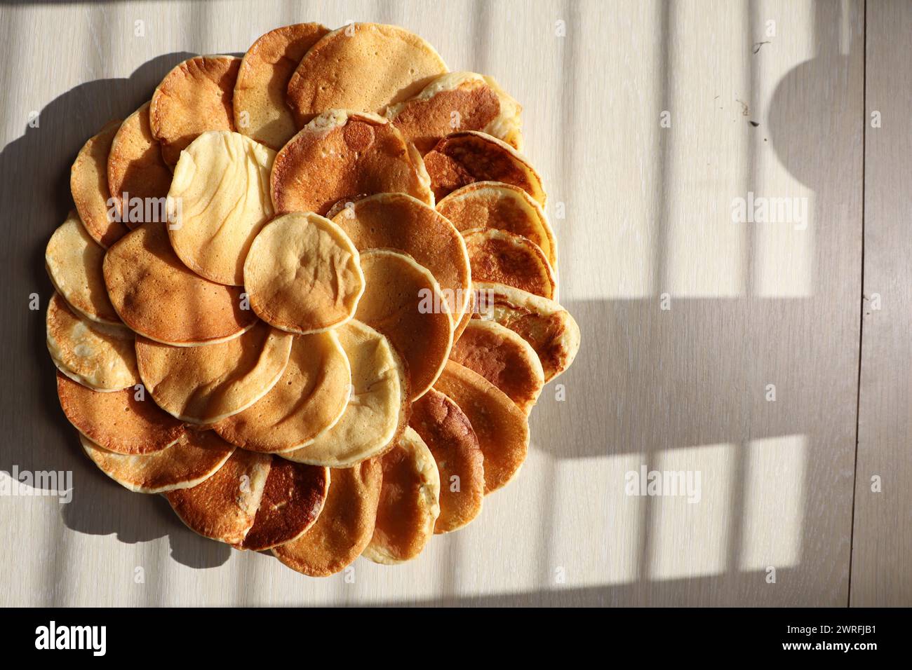A pancake flower centerpiece displayed on a wooden table Stock Photo