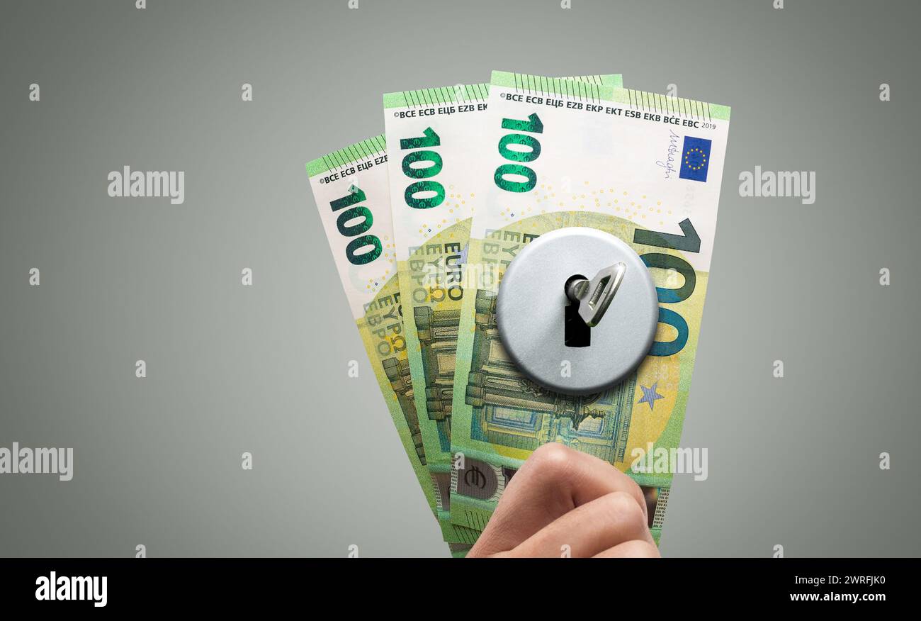 Key in a Lock on Euro Banknotes - Financial Concept Stock Photo
