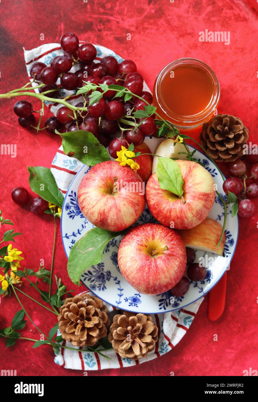 Still life with red apples on textured red background. Space for text. Healthy eating concept. Stock Photo