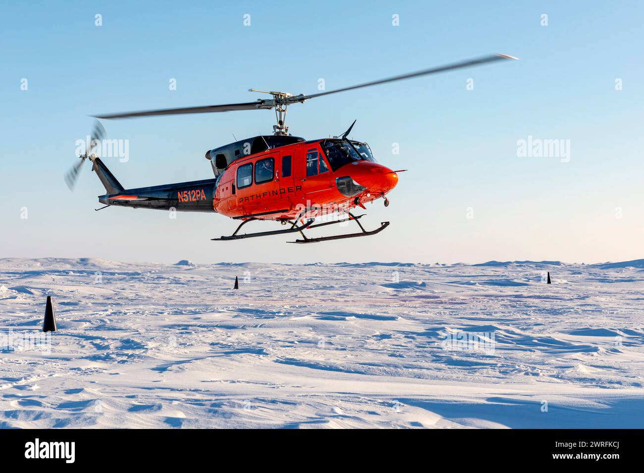 A Bell 212 helicopter lands at Ice Camp Whale during Operation Ice Camp (ICE CAMP) 2024 Stock Photo