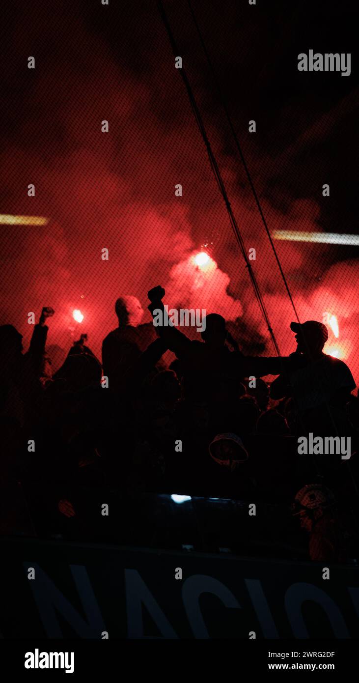 Fans of Benfica with flares (pyrotechnics)  during Taca de Portugal  23/24 semifinal game between Sporting CP and SL Benfica at Estadio Jose Alvalade, Stock Photo