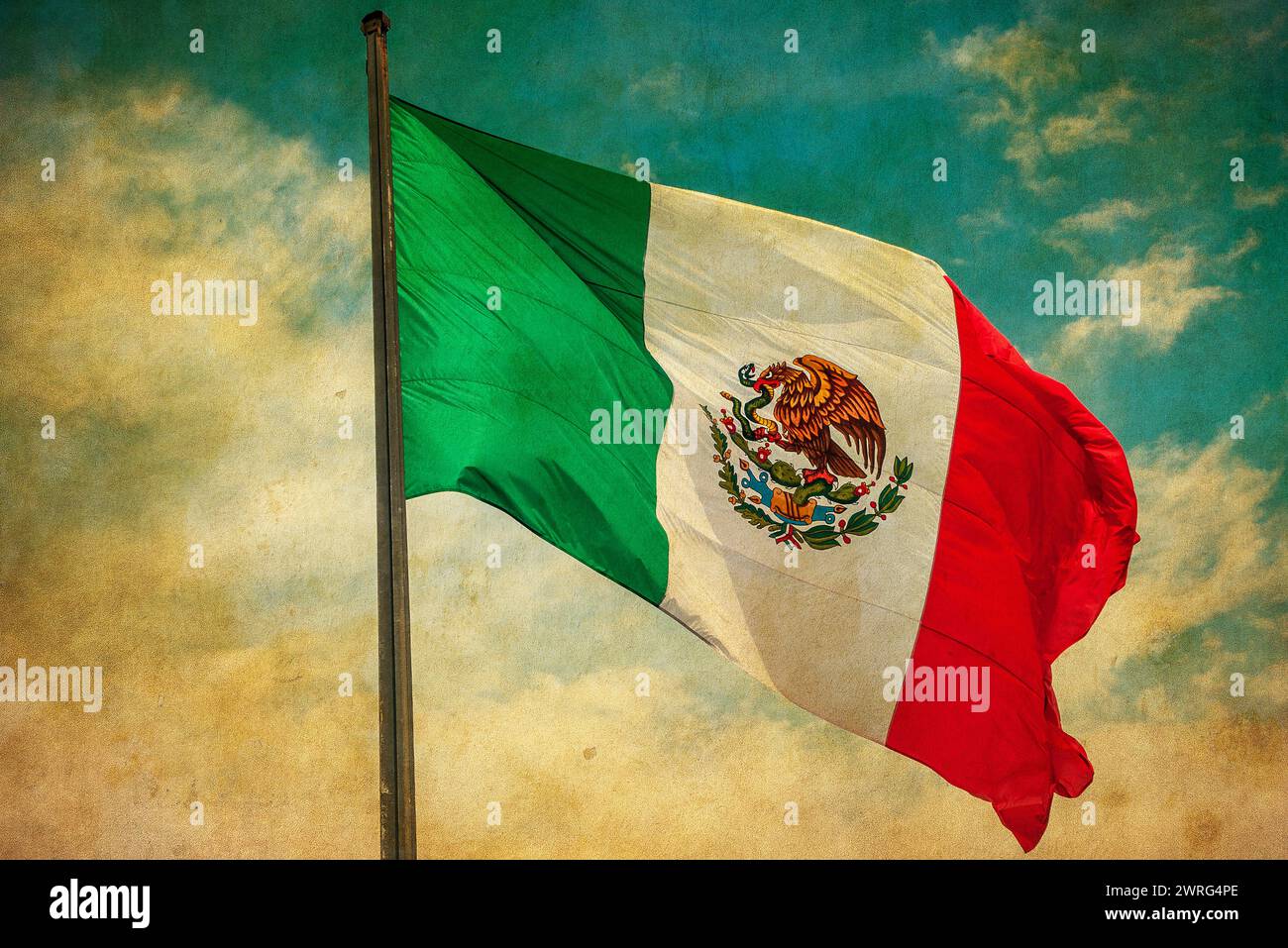 Grunge image of Mexico flag over blue cloudy sky Stock Photo