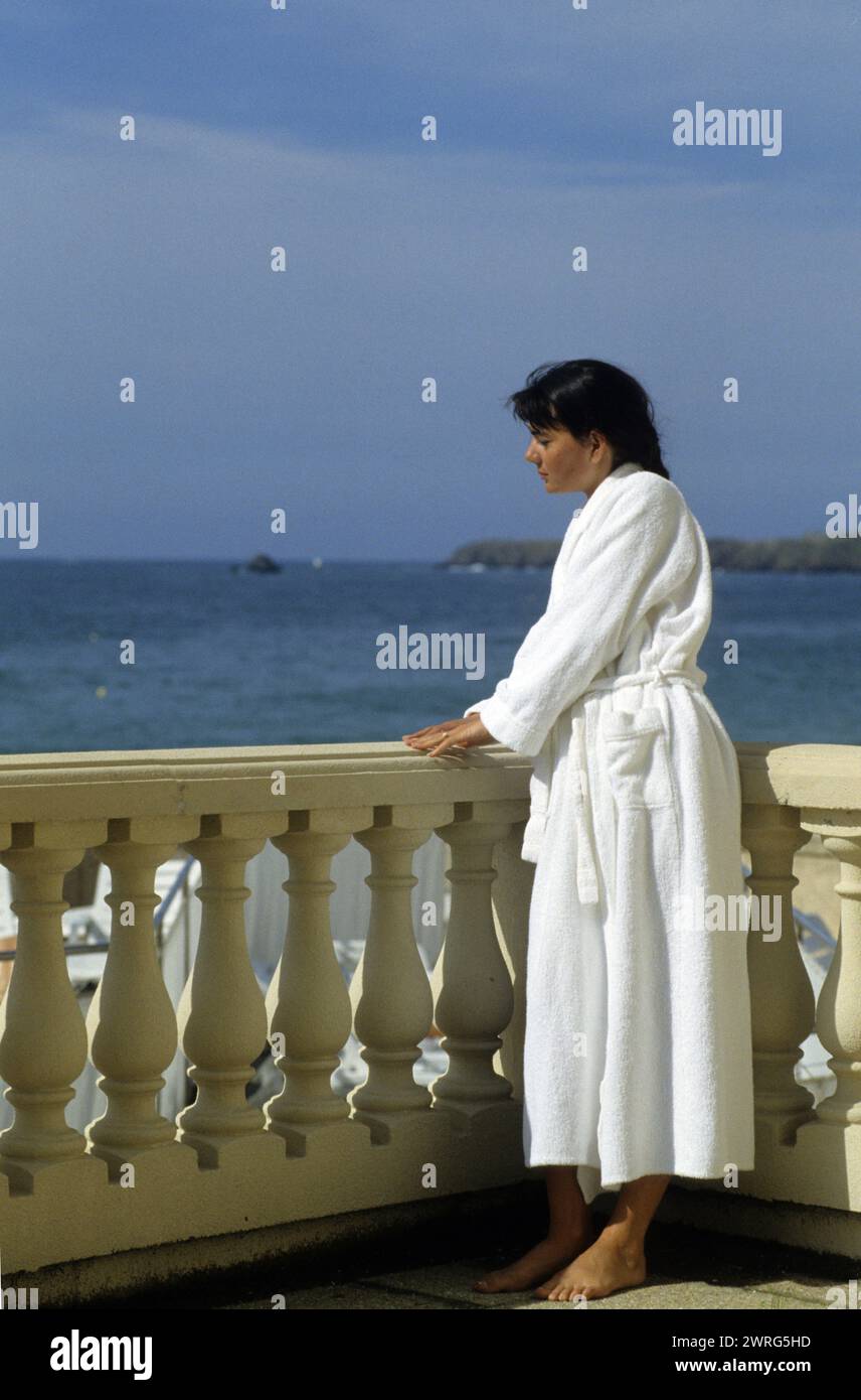 black hair young woman st malo france spa resort thalassotherapy looking horizon from terrasse  spa resort Stock Photo