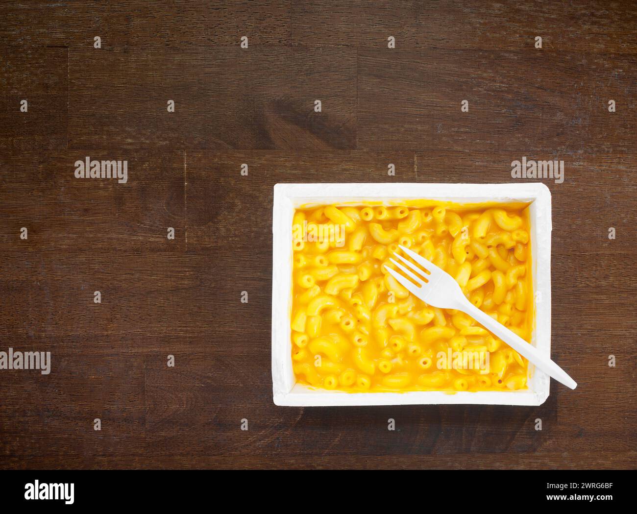Ready to eat macaroni and cheese microwave dinner and plastic fork Stock Photo