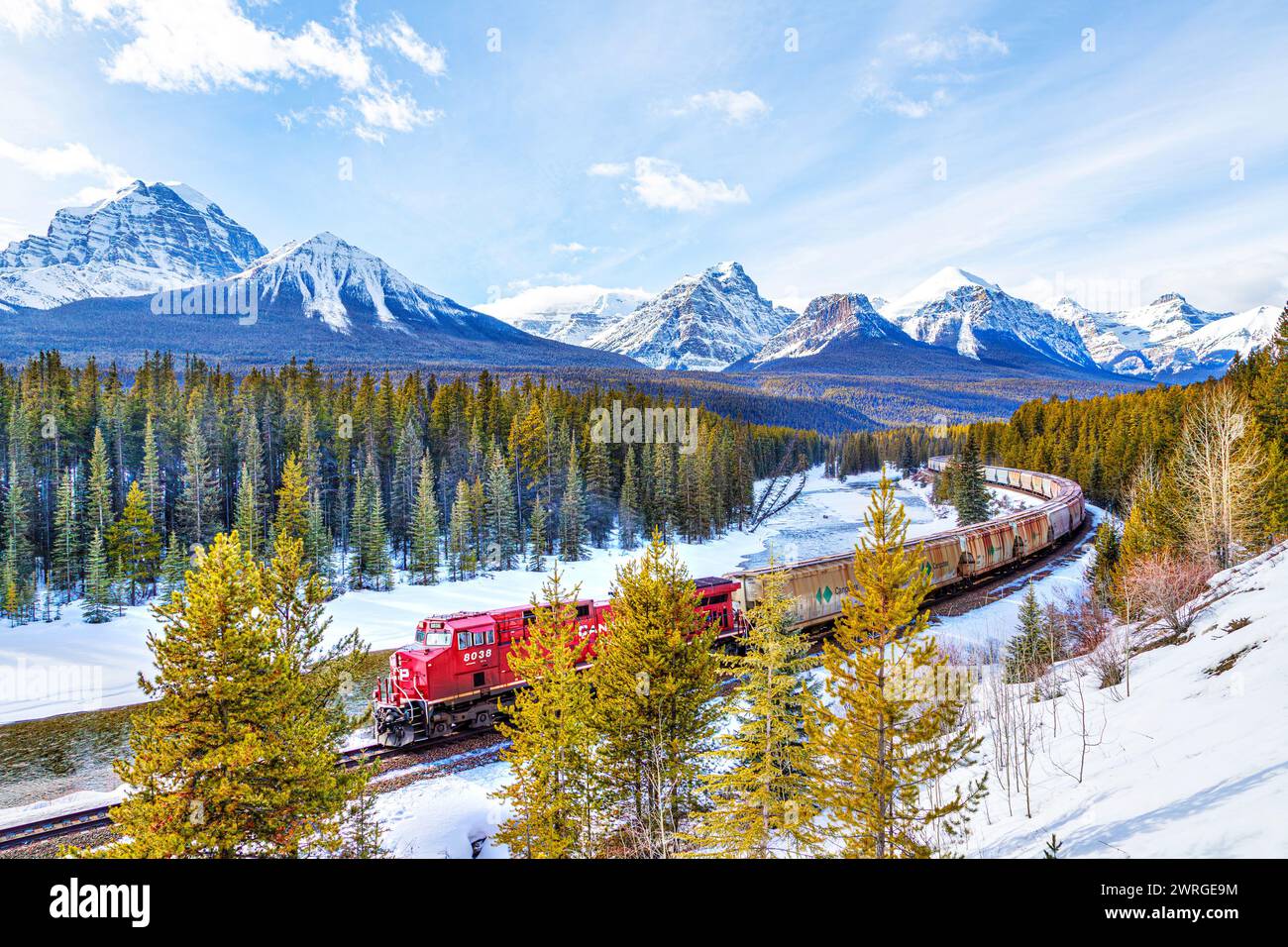 BANFF, CANADA - FEB. 22, 2024: Canadian Pacific Railway cargo train passes through Morant's curve in the Bow Valley of Banff National Park during wint Stock Photo