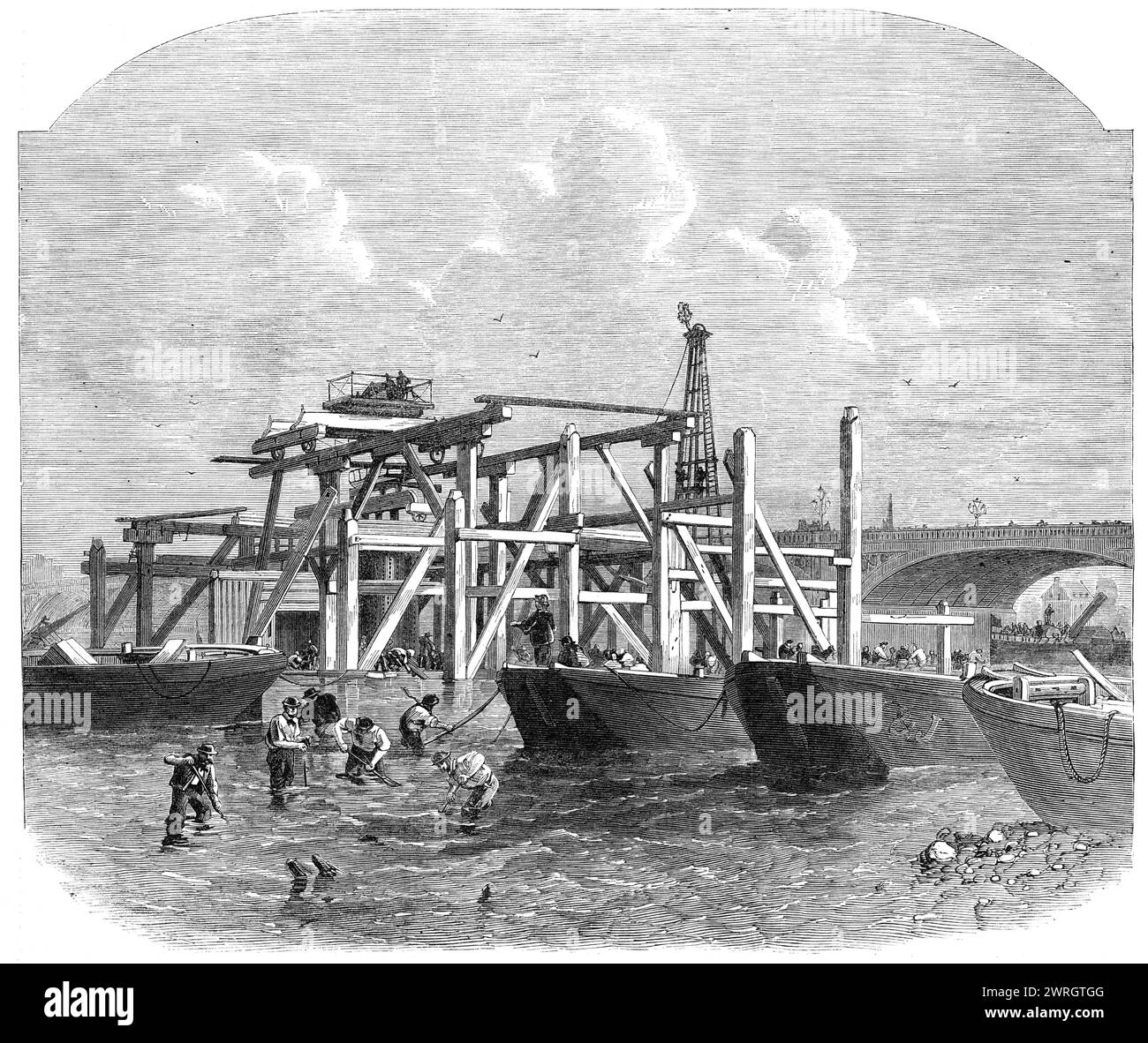 Commencement of the Thames Embankment works near Westminster Bridge, 1864. View of '...piles being driven in, and scaffolding of an extensive character being erected to support and carry the heavy cranes to be used in sinking caissons. This work is preparatory to forming a cofferdam, and thereafter proceeding with excavations for a solid foundation, which must necessarily be laid very deep...The caissons are twelve feet by seven, and the coffer-dams...are remarkable for being constructed, not of timber...but of iron, which, it is thought, will afford great advantages over the old-fashioned mat Stock Photo