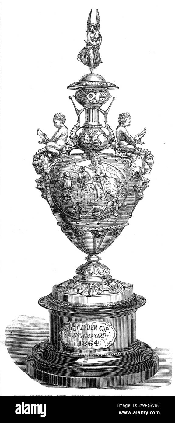 The Clifden Cup, won at the Stamford Races, 1864. 'The Clifden Cup, of silver, was made by Mr. Hancock, of Bruton-street. It is of classical outline, and enriched with ornaments in the style of the fifteenth century. The principal subject is a bas-relief representing Prince Edward rescuing his father (Henry III.) at the Battle of Evesham, which overthrew the Montfort family and restored Henry to full possession of the crown. The handles are moulded into the figures of genii mounted upon grotesque dragons, and on the top is a figure of Fame distributing wreaths, which figure, as well as the gro Stock Photo