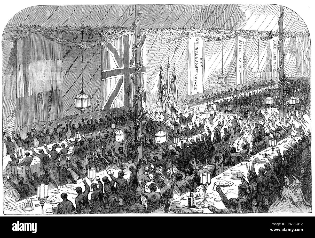 Farewell banquet to the 109th Regiment at Kurrachee, [modern Karachi, Pakistan], 1864. '...the European residents...gave a farewell entertainment to that gallant corps...the whole regiment, including the women and children, were invited to dinner. Two long rows of tents...were pitched, beautifully decorated and lighted for the occasion...Some nine hundred persons sat down to the repast provided, which was of the most substantial land, while the hospitable folks of Kurrachee, both ladies and gentlemen, moved along the ranges of tables to see that their guests were properly served. Cheer after c Stock Photo