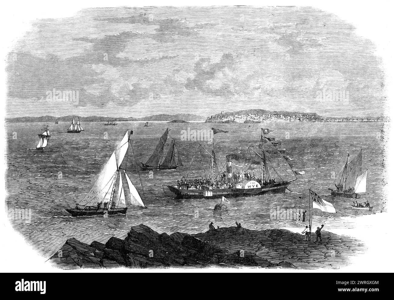 Laying the foundation-stone of Brean Down Breakwater, Weston-Super-Mare, 1864. 'View of...the moment when the stone was lowered from the little steam-boat the Wye, on board which a company of about two hundred ladies and gentlemen were assembled. The immersion of this stone took place at a distance of some hundred yards from the shore, in about 70 ft. of water. It was greeted with loud cheering by a multitude of people on land, as well as by those afloat in the numerous boats which hovered around. Flags were hoisted, a salute of cannon was fired, and a band of music on board the Wye struck up Stock Photo