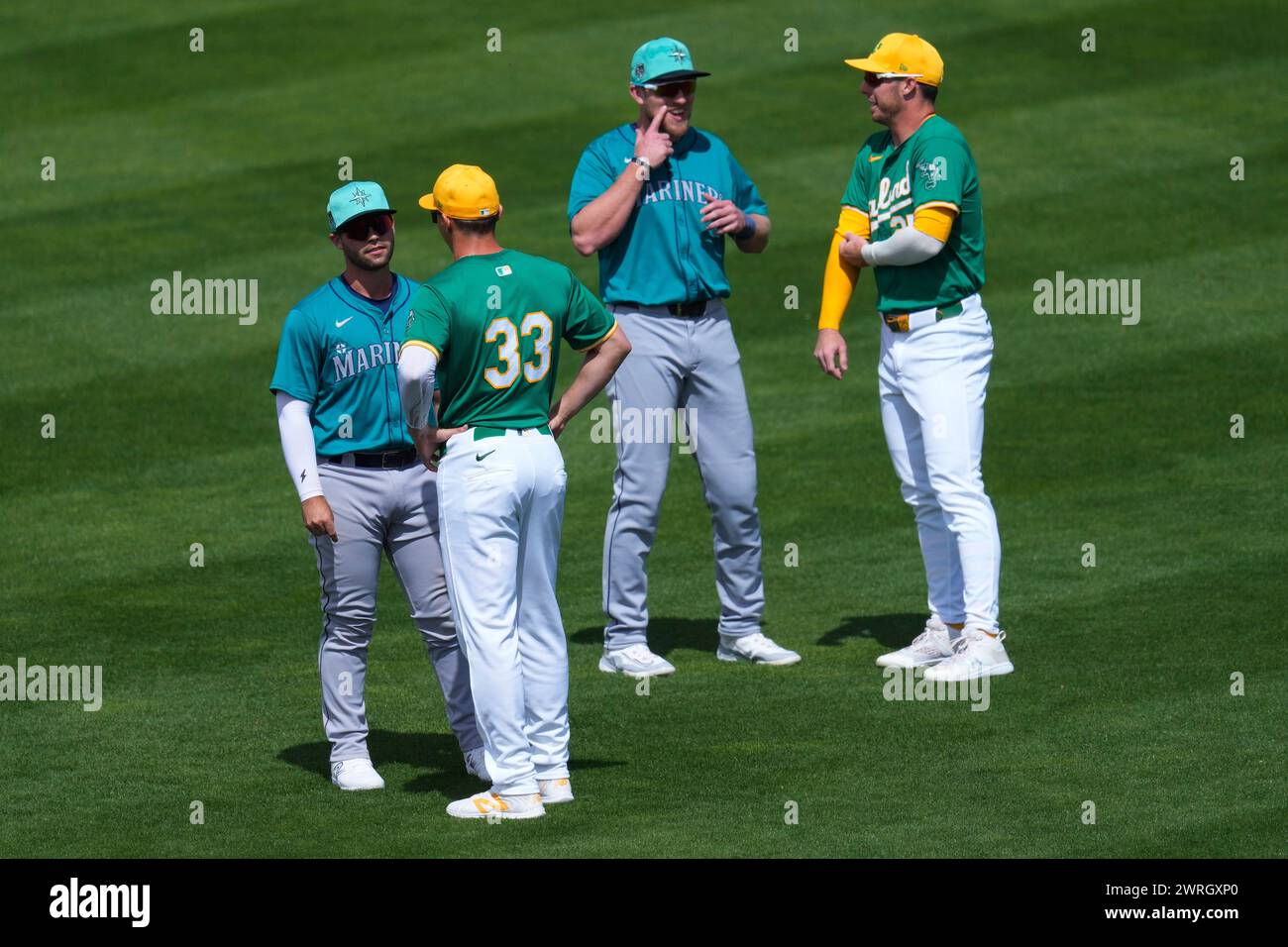 Oakland Athletics' Brent Rooker, right, and J.J. Bleday (33) speak with