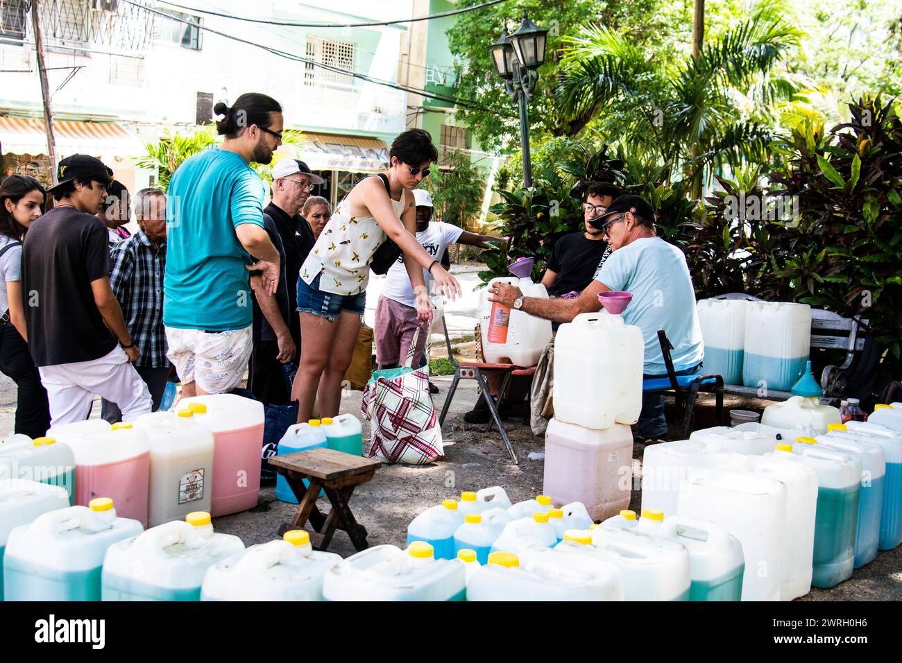 People getting government sponsored free laundry detergent at a park in Havana, Cuba. Stock Photo