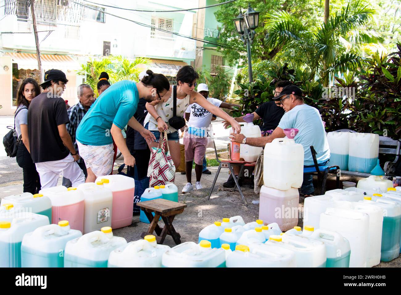 People getting government sponsored free laundry detergent at a park in Havana, Cuba. Stock Photo