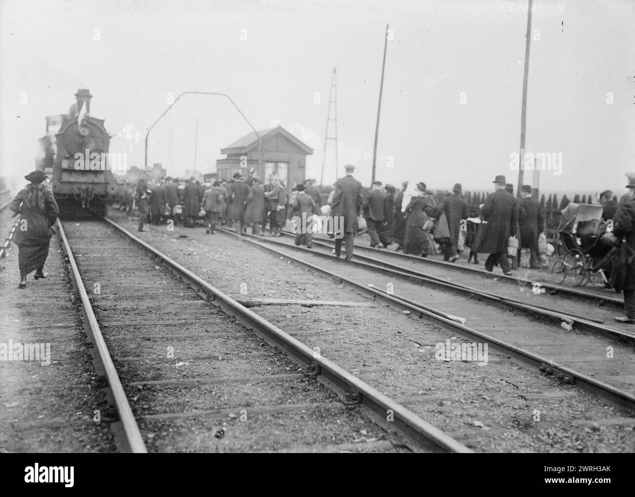 Antwerp refugees fleeing to Holland, 1914. Shows refugees walking on railroad tracks on way to Holland during World War I. Stock Photo