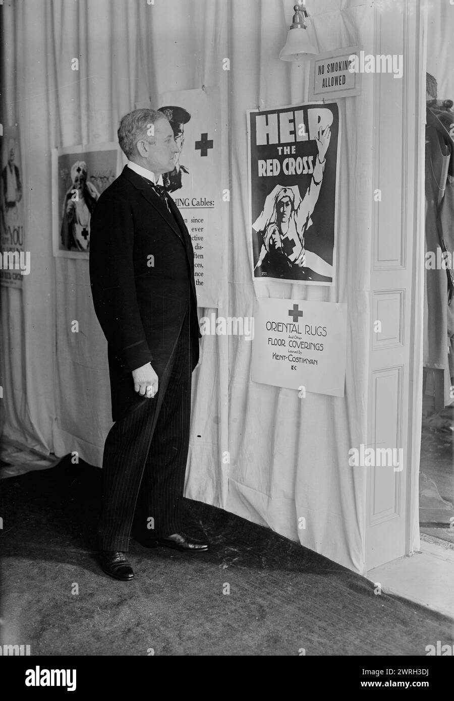 Whitehill, between c1915 and c1920. American bass-baritone opera singer Clarence Eugene Whitehill (1871-1932) looking at Red Cross posters during World War I. Stock Photo