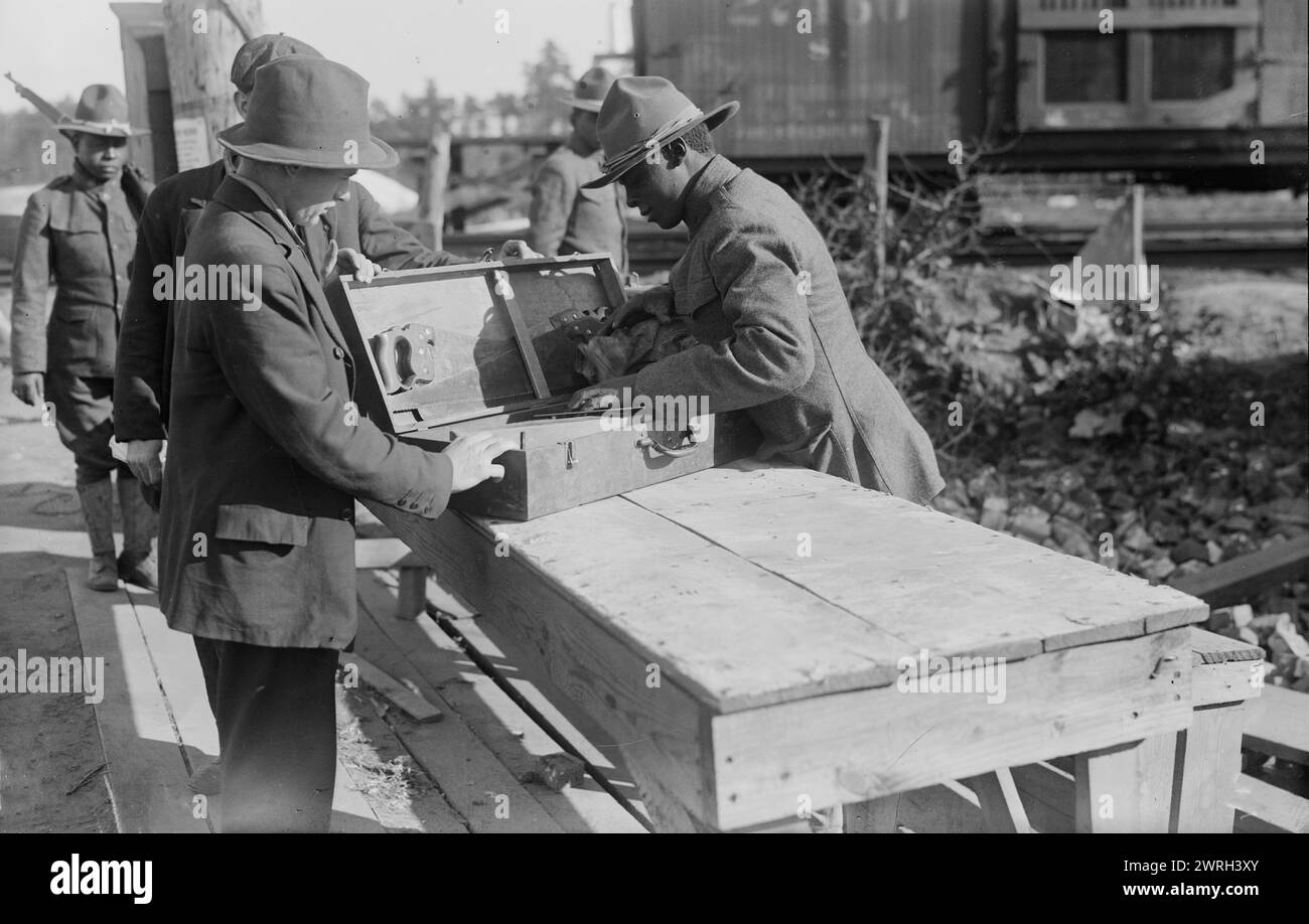 Yaphank, examining packages, 11 Sept 1917 (date created or published later). African American soldier examining a package at Camp Upton, a U.S. Army installation located on Long Island, in Yaphank, New York, during World War I. Stock Photo