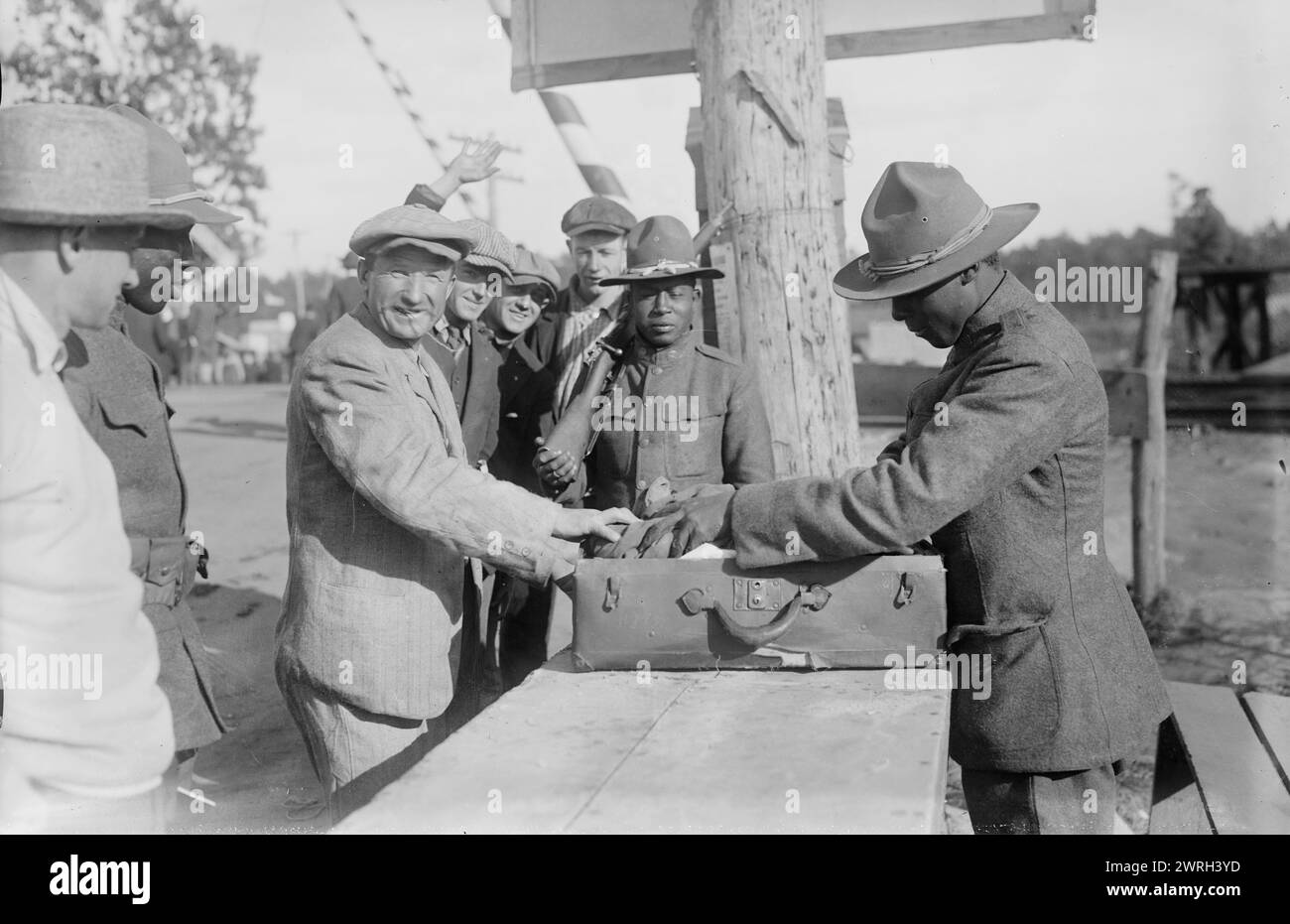 Examining pkges, Camp Upton, Sept 1917. African American soldiers looking at packages at Camp Upton, a U.S. Army installation located on Long Island, in Yaphank, New York, during World War I. Stock Photo