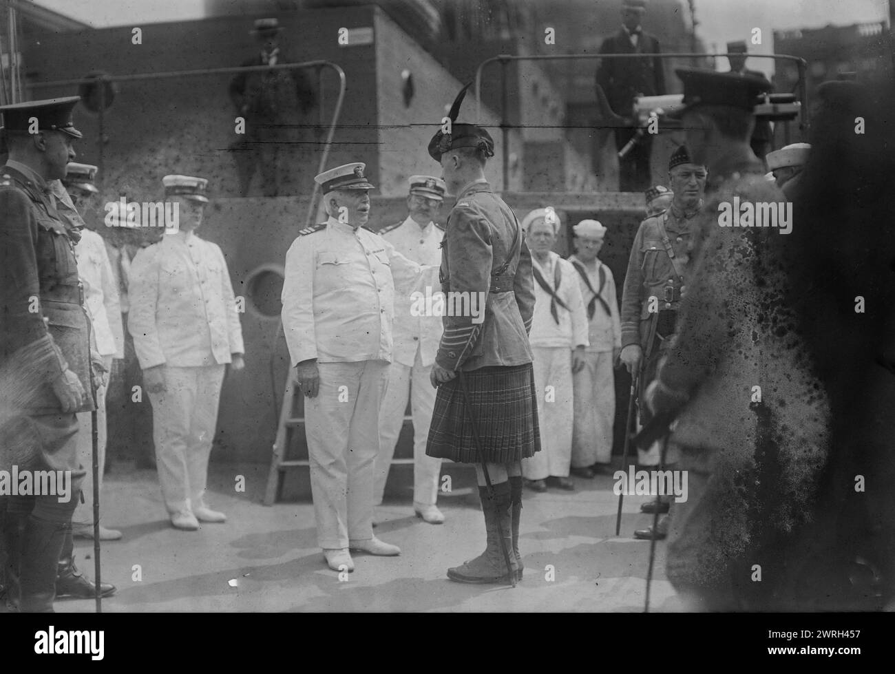 Captain Adams receiving &quot;Kilties&quot; on U.S.S. Recruit, July 1917. Captain Charles Albert Adams (1846-1929) a U.S. naval officer who served as the commander of the USS Recruit, a wooden mockup of a battleship built in Union Square, New York City by the Navy to recruit seamen and sell Liberty Bonds during World War I. Adams is greeting members of the Canadian Highlander regiments, (&quot;Kilties&quot;) who were in New York in July 1917 to assist in recruitment. Stock Photo