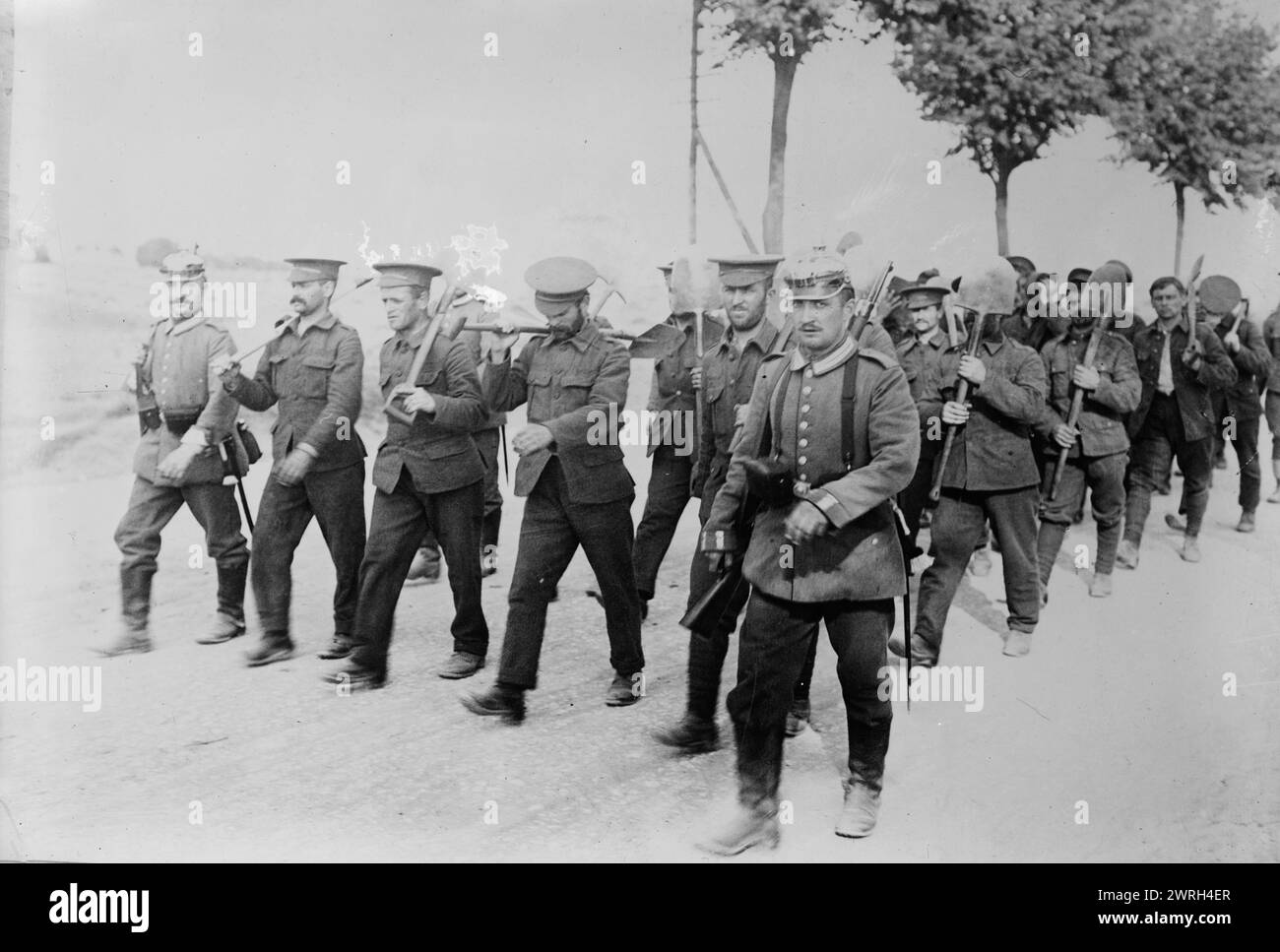 Germany, English prisoners returning from work to Doberitz, between c1914 and c1915. English prisoners, walking in a road with tools, near a prisoner of war camp at Do&#xa8;beritz (now Dallgow-Do&#xa8;beritz), Germany, during World War I. Stock Photo