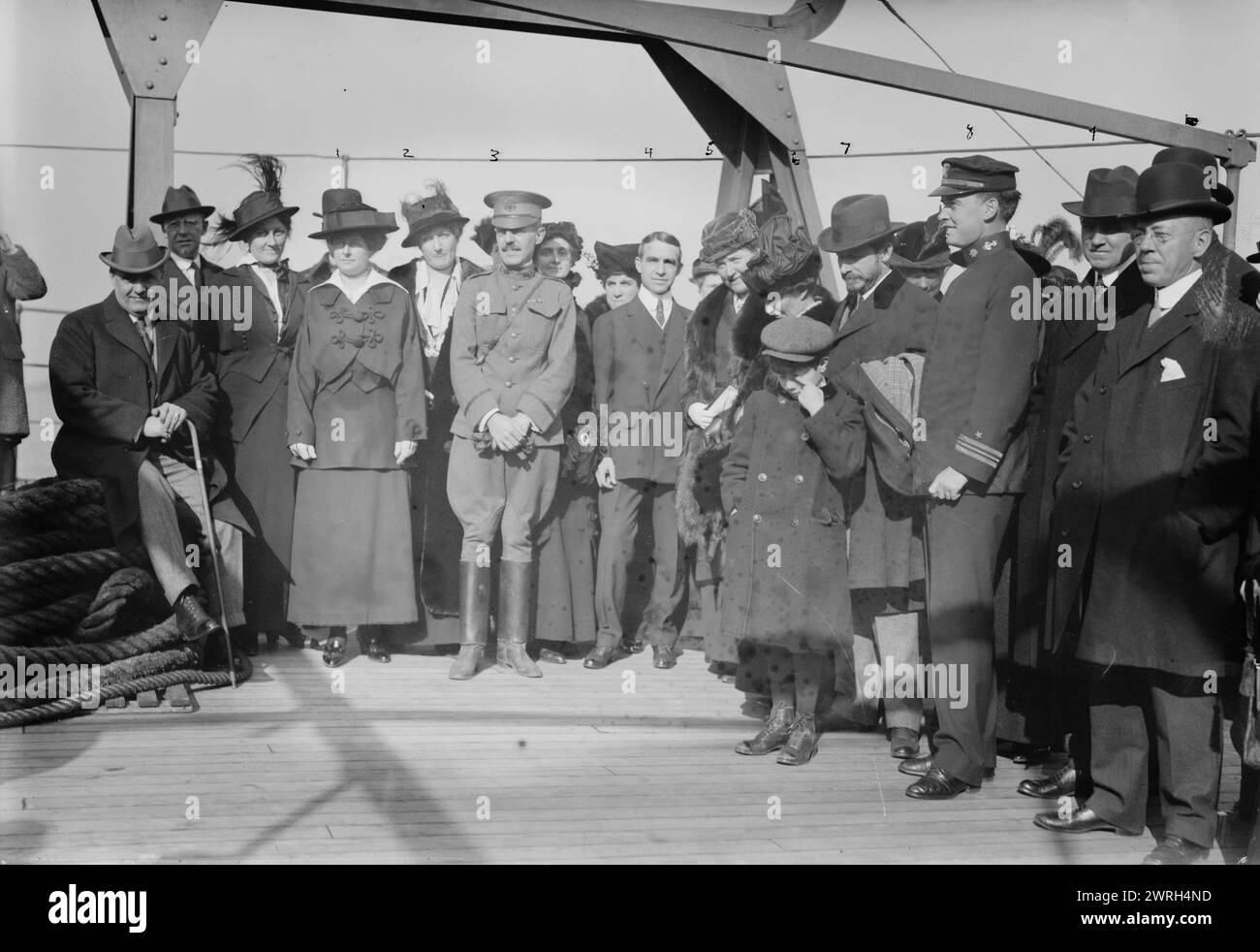 Departure of U.S.S. Jason: Mrs. Chas. Saltzman, Mrs. Lawton, Major Lawton, C.O. Laughlin, Mrs. L. Wood, Mrs. W. Draper, G. McAneny, G.R. Adamson, Lt. Com. C.E. Courtney, 14 Nov 1914. The departure of the U.S.S. Jason which sailed from New York on November 14, 1914 carrying about 6 million gifts for the children of Europe who were affected by World War I. People depicted include: Mrs. Leonard Wood, wife of the Commander of the Army of the East; Mrs. W.K. Draper (Helen Fidelia Draper), head of the New York Chapter of the Red Cross; George McAneny, President of the New York City Board of Aldermen Stock Photo