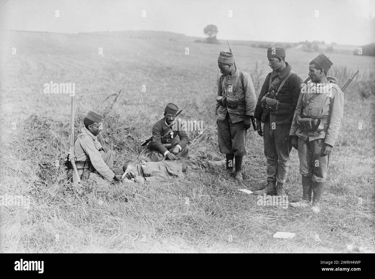 French succoring wounded German, 1914. French Moroccan soldiers, between Villeroy and Neufmoutiers, France, caring for a wounded German soldier during World War I. Stock Photo