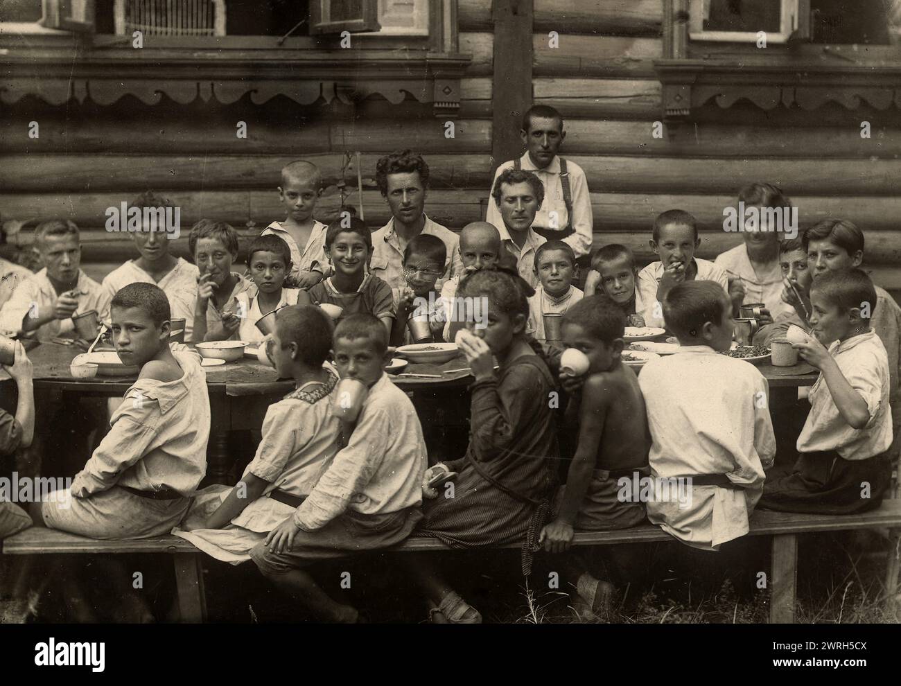 The Jewish Model Children's Commune in Malakhovka Near Moscow, 1921-1922. Children at Dinner. Among Them - Managing the Colony Comrad Shvartsman and Known Artist Mark Shagal (Together with Composer Engelem), Who Worked at this Time in the Colony.  In the early part of the Stalin era, the Kremlin established a new administrative territory in the Soviet Far East--the Jewish Autonomous Region--to serve as a Jewish homeland. The capital of the region was the city of Birobidzhan. This album includes 274 photographs of the early years of Birobidzhan, beginning in the late 1920s. National Library of Stock Photo