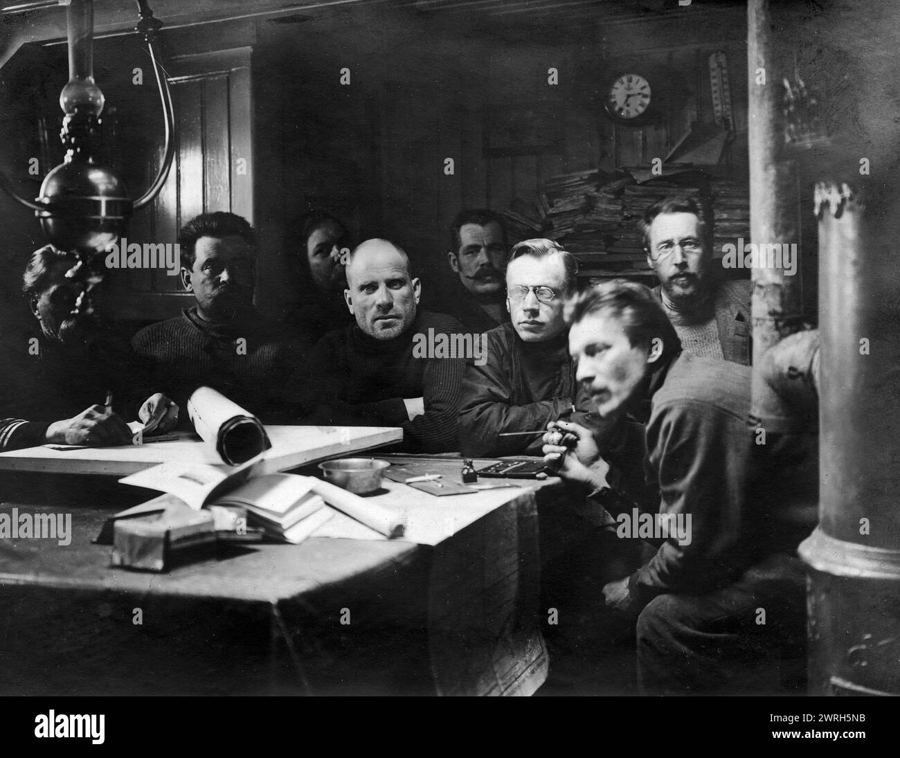 In the Mess-Room of the Ship &quot;Saint Martyr Foka&quot;, 1913. From a collection consisting of an album and individual photographs from the family archive of geologist Mikhail Alekseevich Pavlov (1884-1938). The collection depicts an expedition undertaken by Senior Lieutenant Georgii Iakovlevich Sedov (1877-1914) in the years 1912-14. Sedov, whose health was already failing when he set out for the pole by sled in early 1914, died before reaching his objective. The members of the expedition nonetheless carried out extensive surveying and scientific observations while wintering on Novaya Zeml Stock Photo