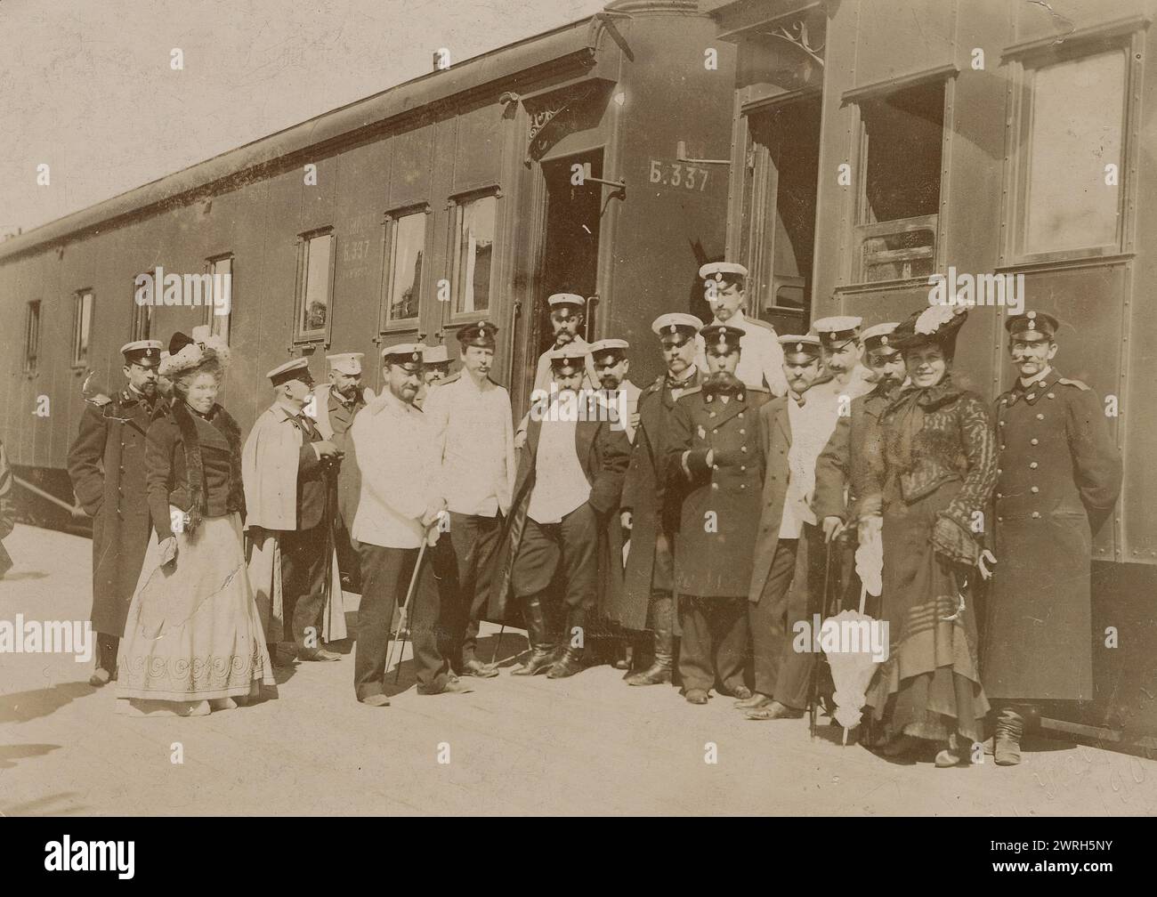 Railway employees against the background of train cars, 1910-1919. From a collection of 136 photographs of Irkutsk from the late nineteenth and early twentieth centuries. The photographs show views of both the city of Irkutsk and countryside of Irkutsk Province; methods of transportation; and the citizenry, including their way of life, social activities, and forms of entertainment. Irkutsk Municipal History Museum Stock Photo