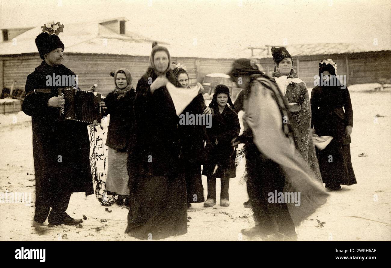 Mummers on the streets of the Znamensky Glass Factory on Christmastide, 1913-1914. From a collection which  includes more than four hundred photographs of daily life in Yenisei Province in the late tsarist period. Photographs include peasants, Cossacks, and high-ranking officials. Krasnoiarsk Krai Museum of Regional History and Folklife Stock Photo