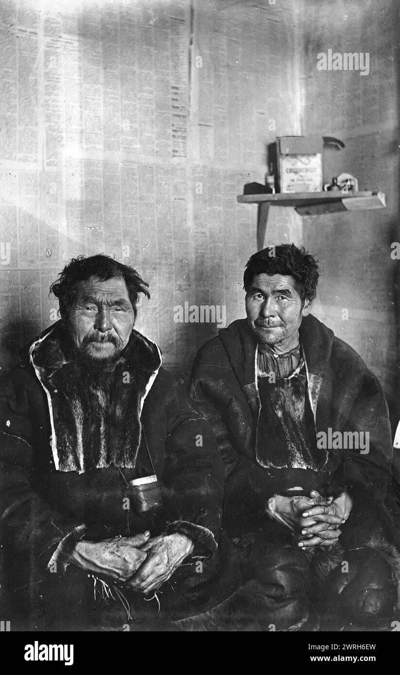 Two Chukchi in kukhlyankas, 1910-1929. From an album containing 296 works offering a glimpse of life in the Russian Far Northeast in the first third of the twentieth century. It includes nature scenes of Kamchatka, views of Petropavlovsk and other population centers, and images of the indigenous peoples of Kamchatka and neighboring territories--their occupations and their material culture. Kamchatka Regional Unified Museum Stock Photo