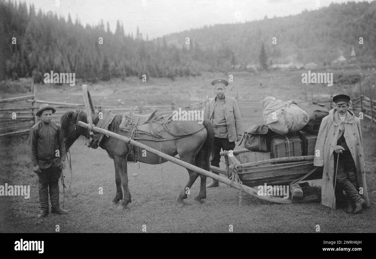 Moving the Expedition Equipment on the Drag Harrow, Near the Ust'-Anzas Ulus, 1913. From a collection of 109 photographs taken during a 1913 topographic expedition to the Gornaia Shoria in the Altai region and another topographic expedition to the Mrasskii region, Kuznetskii District (central part of the Gornaia Shoria). The photographs reflect both expedition activities and the life of the people in this region. Altai State Regional Studies Museum Stock Photo