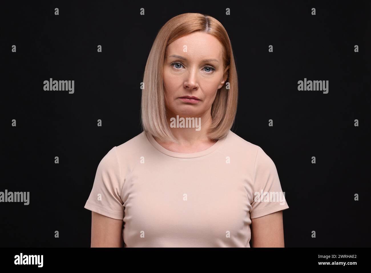 Portrait of sad woman on black background Stock Photo - Alamy