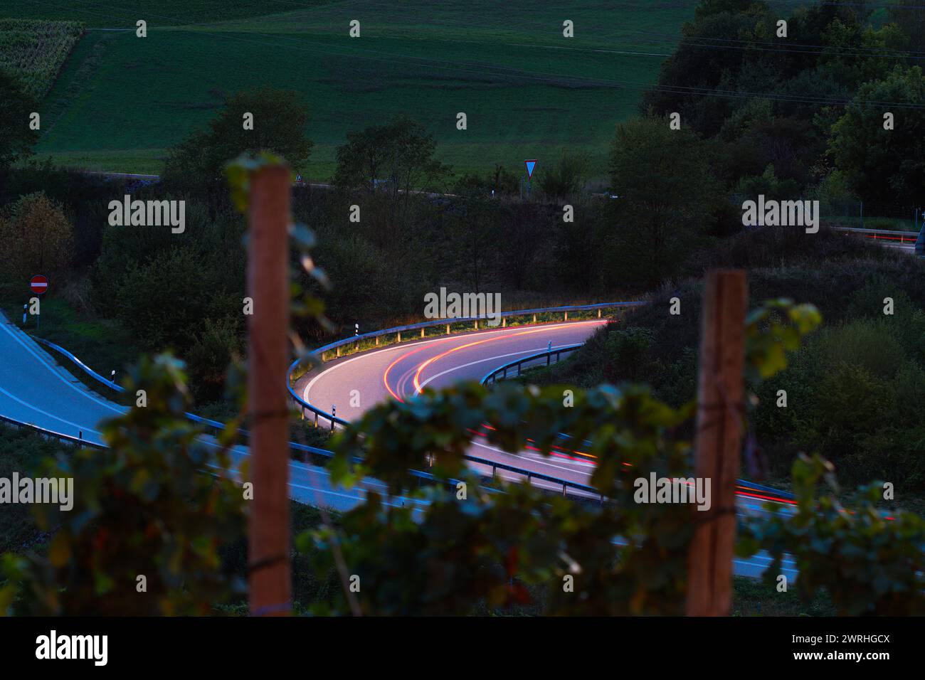 Car back light on a road at night, long exposure Stock Photo