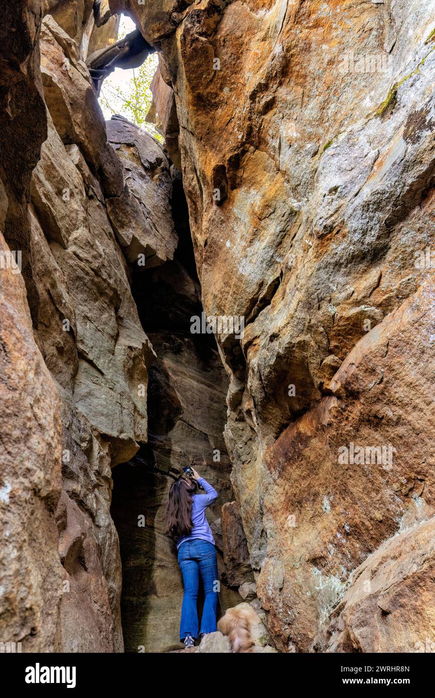Woman taking picture in slot canyon - Granite City, Nantahala National Forest, near Cashiers, North Carolina, USA Stock Photo