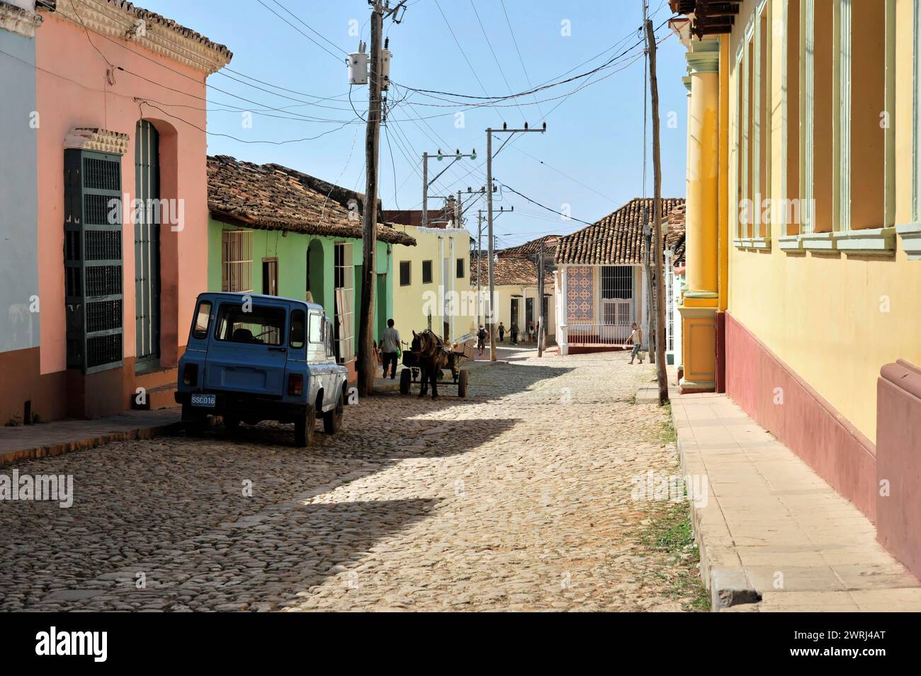 Historic city street with colourful buildings and cobblestones, Trinidad, Cuba, Central America Stock Photo