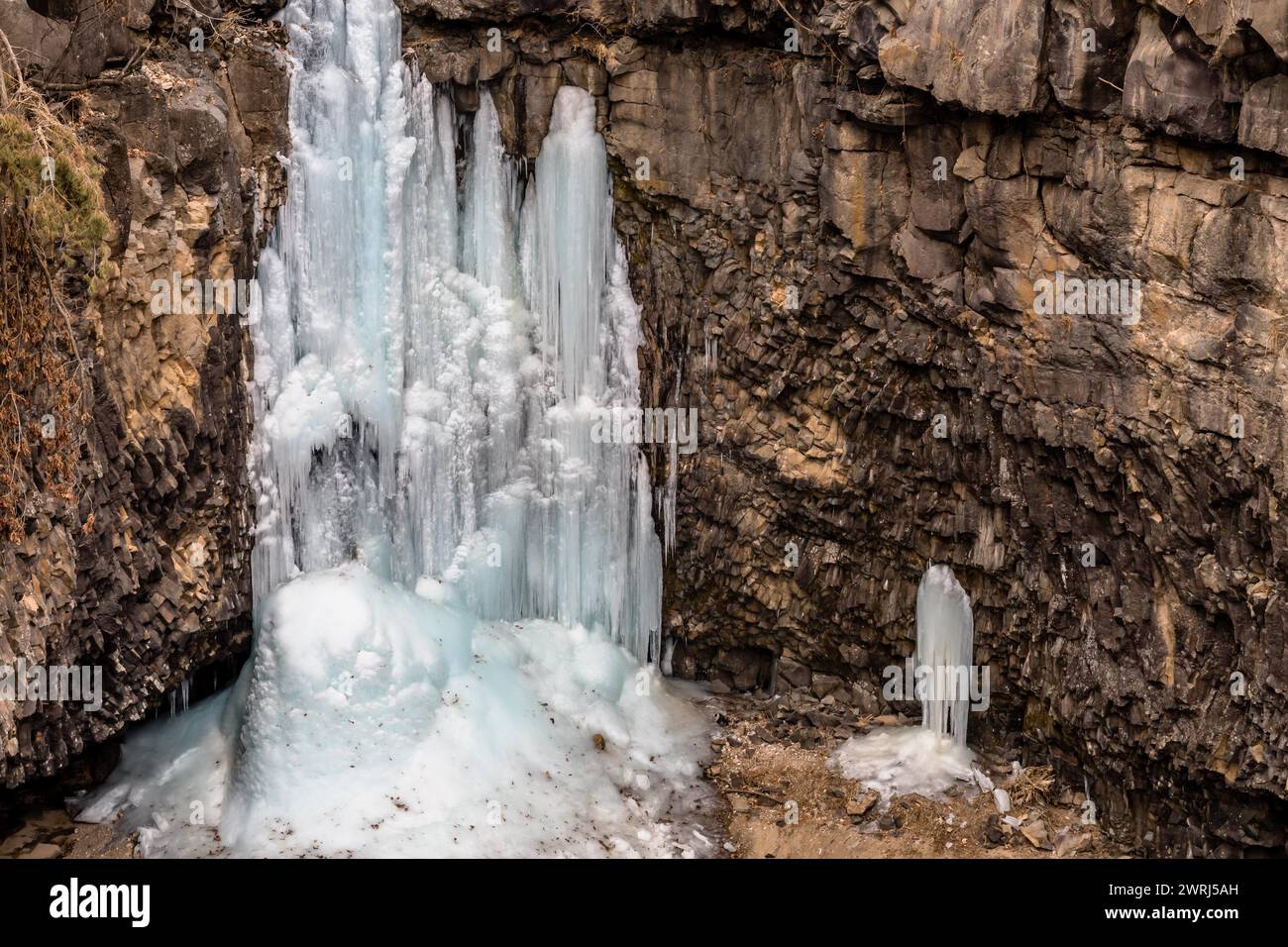 Looking down on frozen waterfall in deep crater located in Gyeonggi province of South Korea Stock Photo