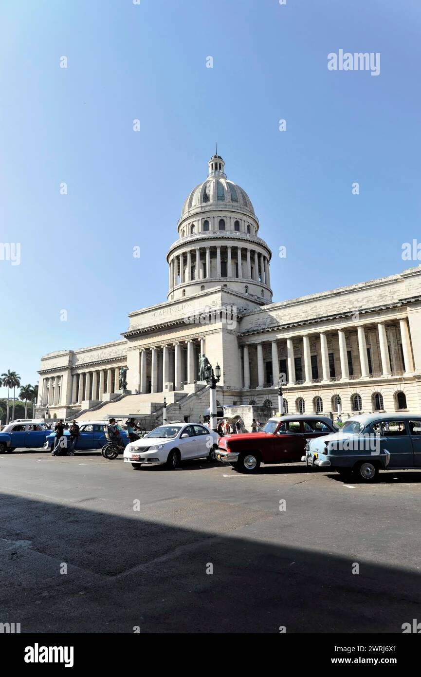 City view with people and cars in front of the Capitol with blue sky in the background, Havana, Cuba, Central America Stock Photo