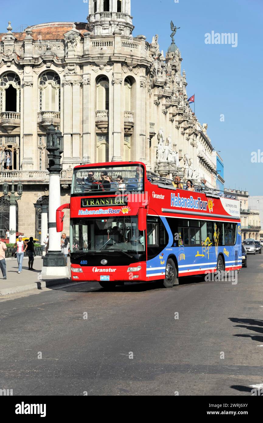 Red double-decker bus for city tours in front of historic buildings, Havana, Cuba, Central America Stock Photo