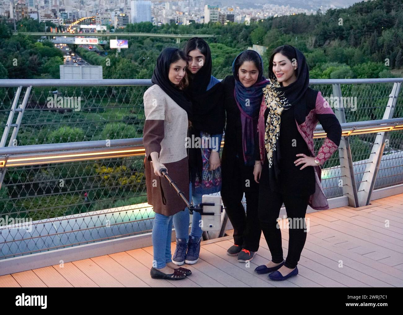 Women take selfie photos of themselves on the Tabiat Bridge in Tehran, Iran. The 270-metre-long bridge at Ab-o-Atash Park was designed by Iranian Stock Photo