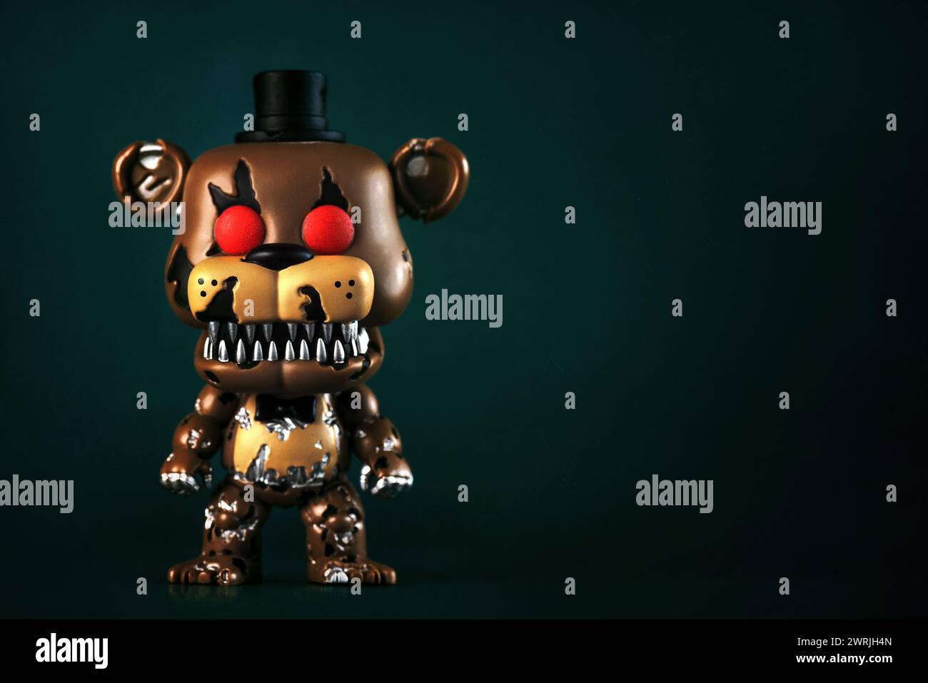 Funko POP vinyl figure of Nightmare Freddy character of the videogames,movies and books Five Nights at Freddy's over green background. Illustrative ed Stock Photo