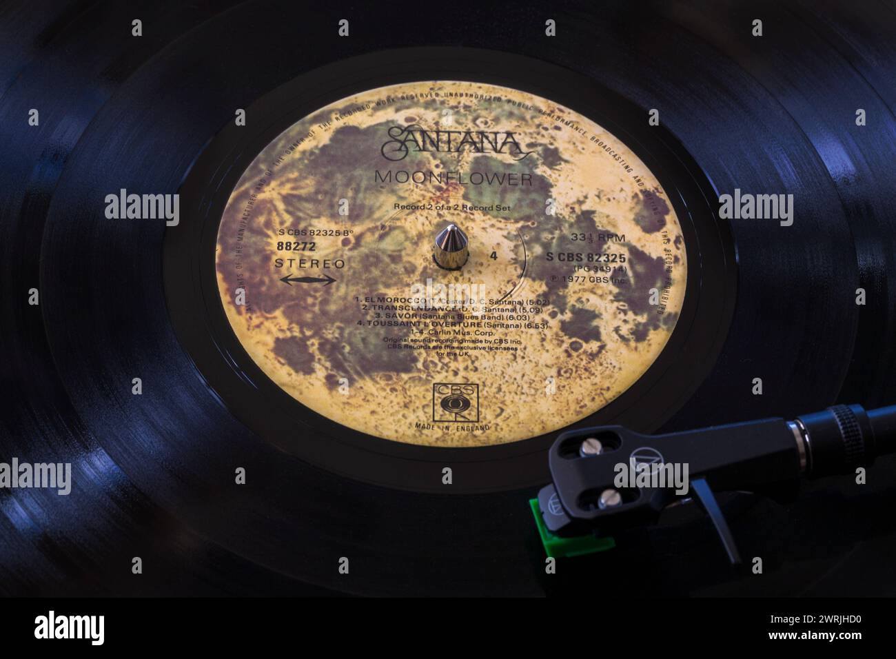 Santana Moonflower vinyl record album LP with tonearm, cartridge, headshell and stylus on turntable record player  - 1977 Stock Photo