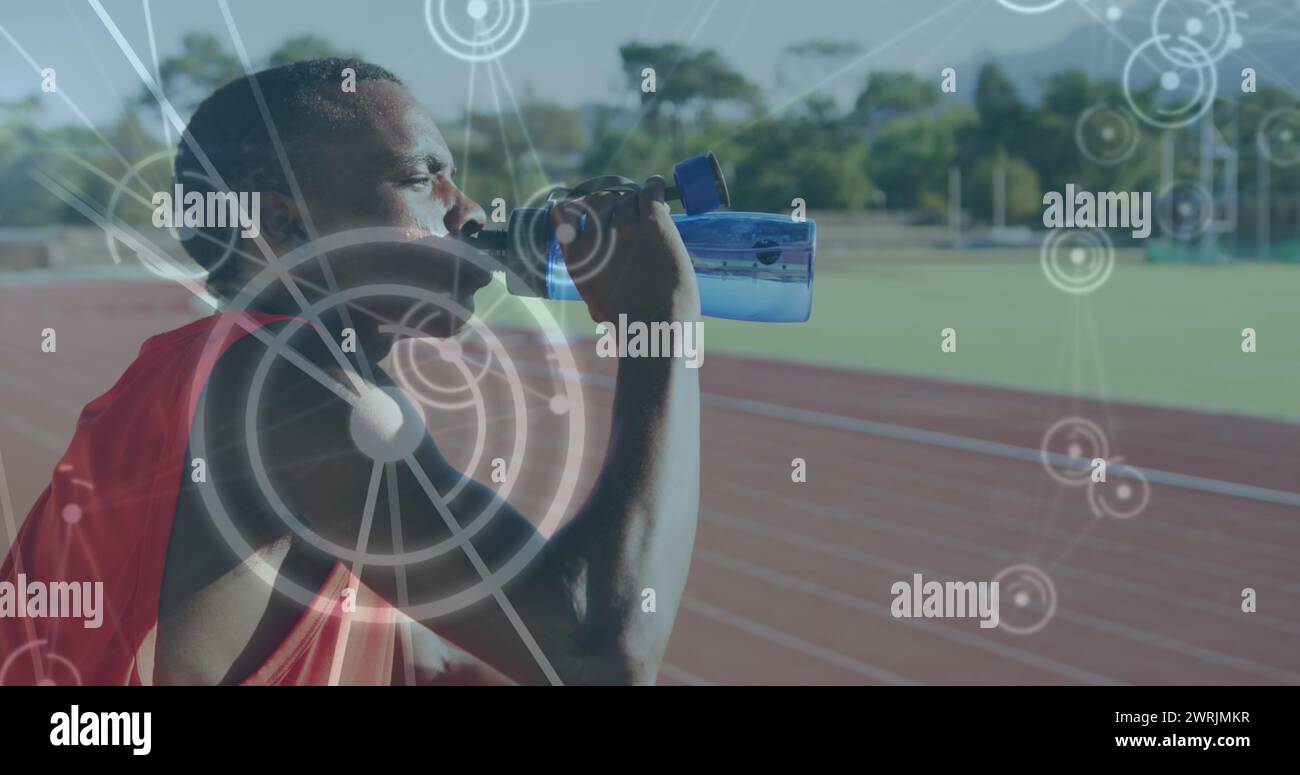 Image of network of connections over male athlete with drinking water on running track Stock Photo